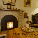 Roaring Fire with a dram and authentic The Balvenie table at The Tannochbrae